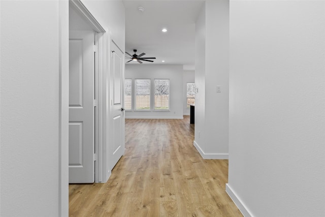 hall with recessed lighting, baseboards, and light wood-type flooring