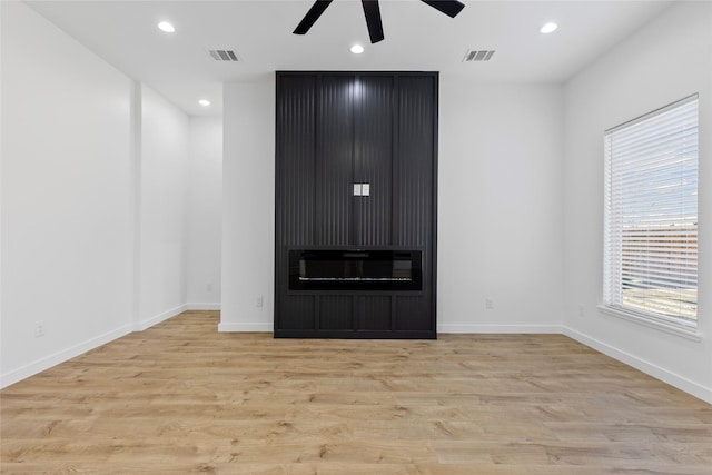 unfurnished living room featuring recessed lighting, visible vents, baseboards, and wood finished floors