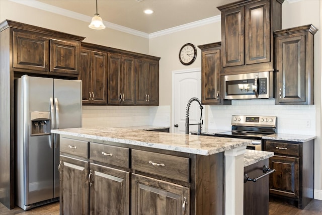 kitchen featuring dark brown cabinetry, a kitchen island, and stainless steel appliances