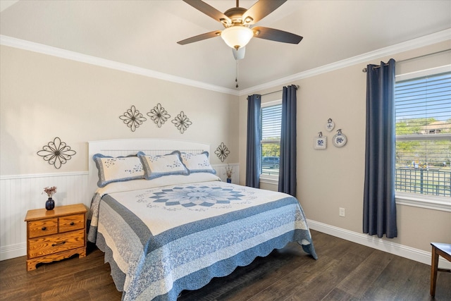 bedroom featuring ceiling fan, wainscoting, dark wood-style flooring, and ornamental molding