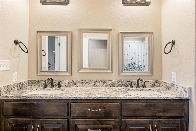 bathroom with double vanity and a sink