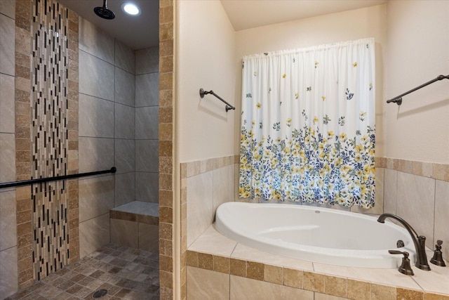 bathroom with tiled shower and a garden tub