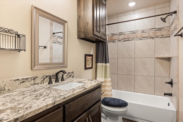 bathroom featuring vanity, shower / tub combo, and toilet