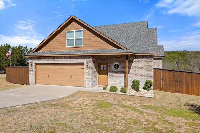 view of front facade featuring driveway, fence, roof with shingles, an attached garage, and brick siding