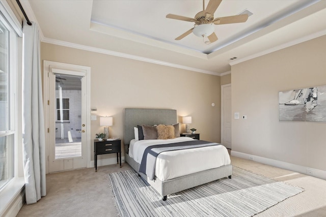 bedroom featuring visible vents, light colored carpet, baseboards, and a tray ceiling