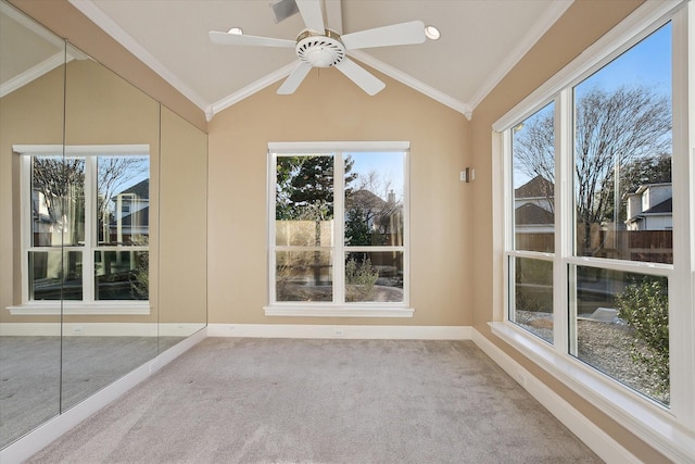 unfurnished sunroom featuring a healthy amount of sunlight, a ceiling fan, and vaulted ceiling