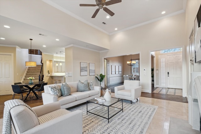 living area featuring visible vents, stairs, and ornamental molding