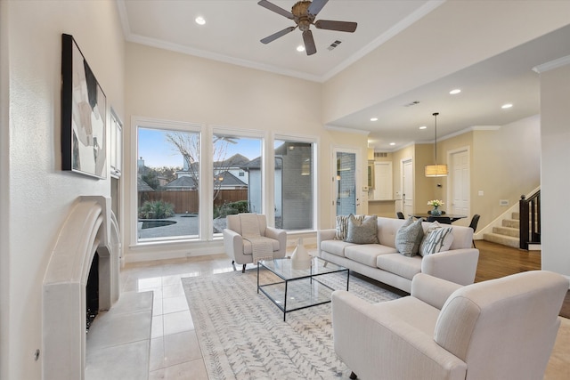 living room with stairway, light tile patterned floors, visible vents, recessed lighting, and ornamental molding