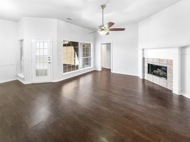 unfurnished living room featuring a tiled fireplace, a ceiling fan, and baseboards