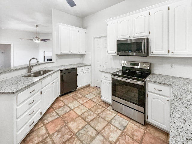 kitchen with white cabinetry, stainless steel appliances, a ceiling fan, and a sink