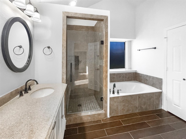 bathroom with vanity, a shower stall, a bath, and wood tiled floor