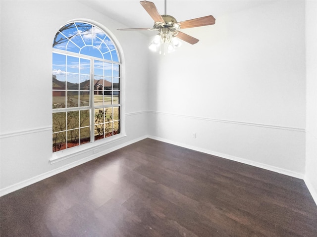 spare room with baseboards and plenty of natural light