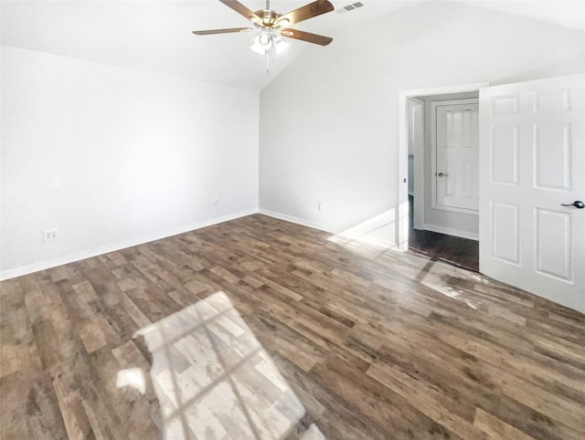 spare room featuring visible vents, baseboards, vaulted ceiling, wood finished floors, and a ceiling fan