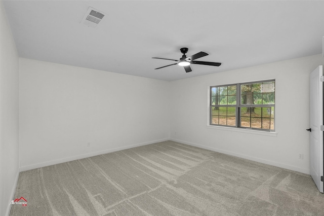 empty room featuring a ceiling fan, carpet flooring, baseboards, and visible vents