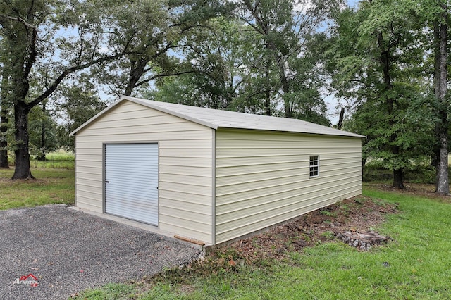 view of outbuilding featuring gravel driveway and an outdoor structure