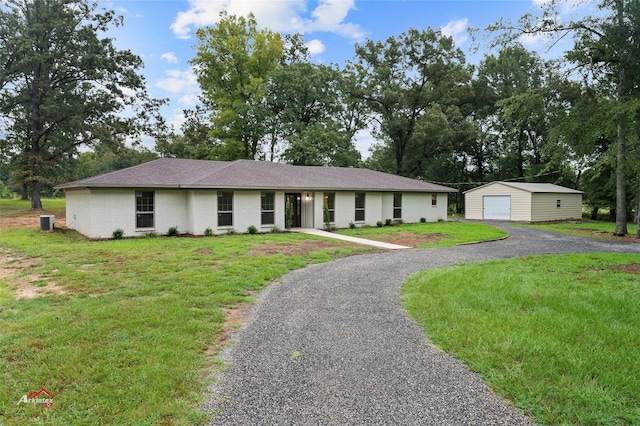 single story home with a front lawn, aphalt driveway, a detached garage, an outdoor structure, and central AC unit