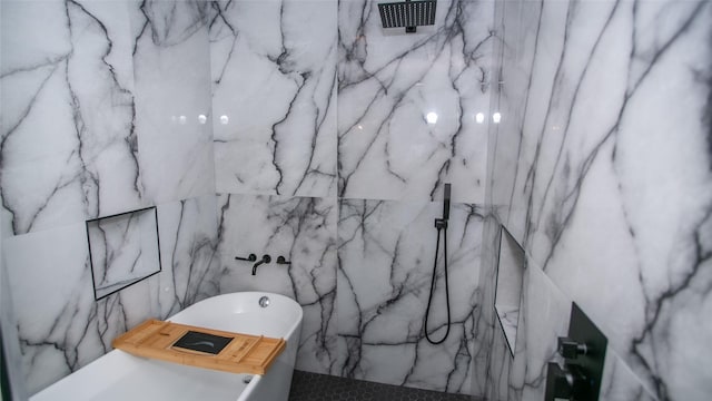 bathroom featuring a marble finish shower and a soaking tub