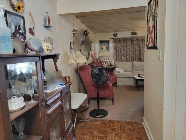 interior space with brick floor and a textured wall