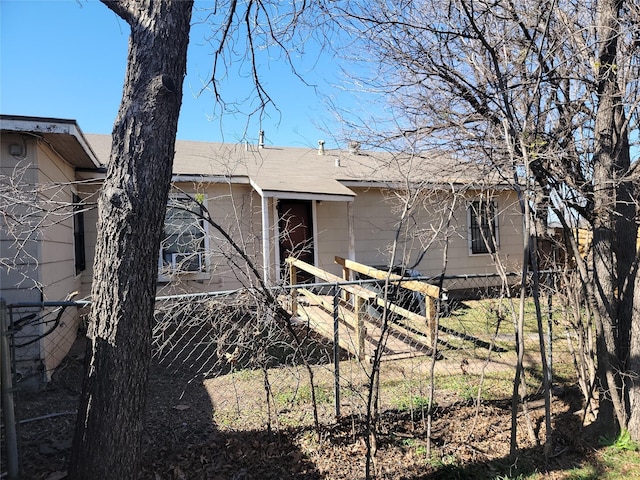 back of property featuring fence