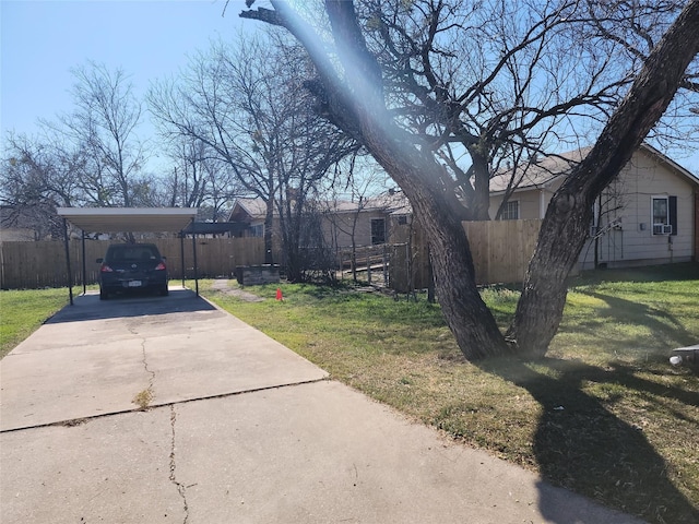 exterior space with concrete driveway and fence