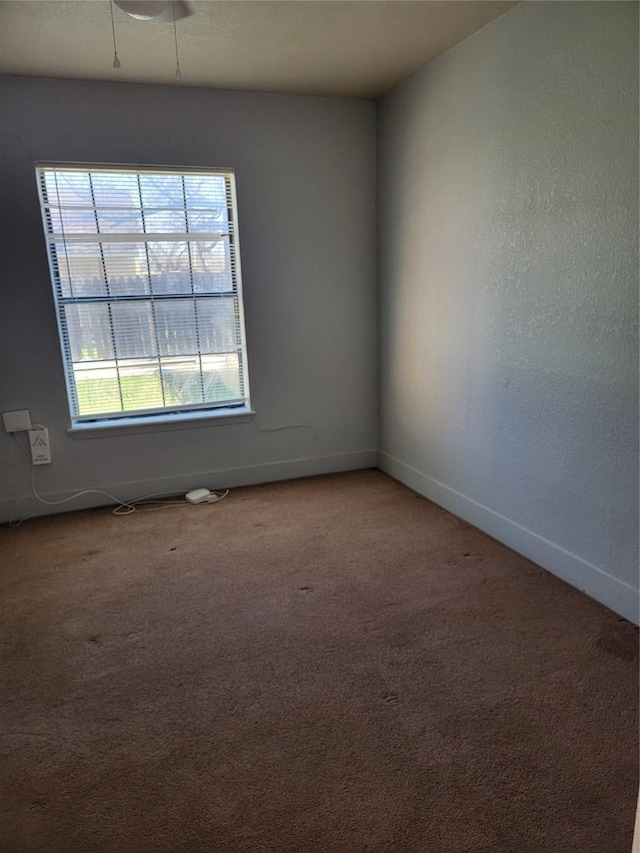 unfurnished room featuring light colored carpet and baseboards