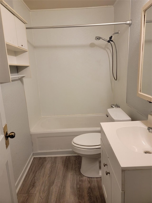 bathroom featuring toilet, vanity,  shower combination, and wood finished floors