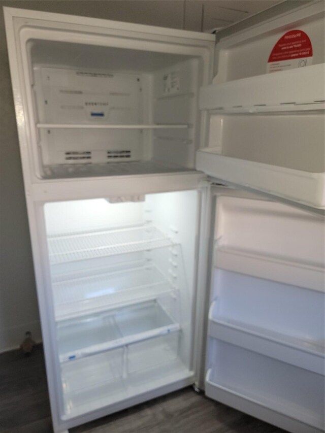 details featuring fridge and dark wood-style flooring