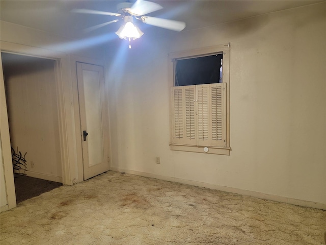 spare room featuring baseboards, ceiling fan, and carpet flooring