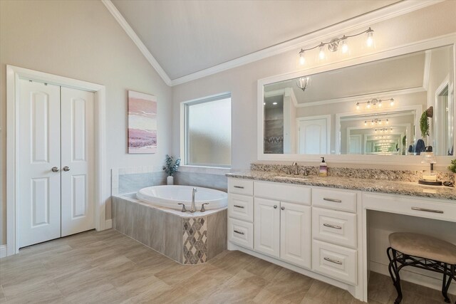 bathroom featuring ornamental molding, wood finish floors, tiled shower, and vanity