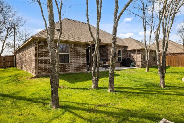 french country inspired facade featuring fence, stone siding, a front lawn, an attached garage, and driveway
