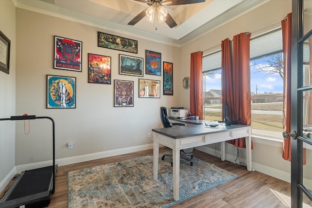 office featuring wood finished floors, ceiling fan, baseboards, and ornamental molding