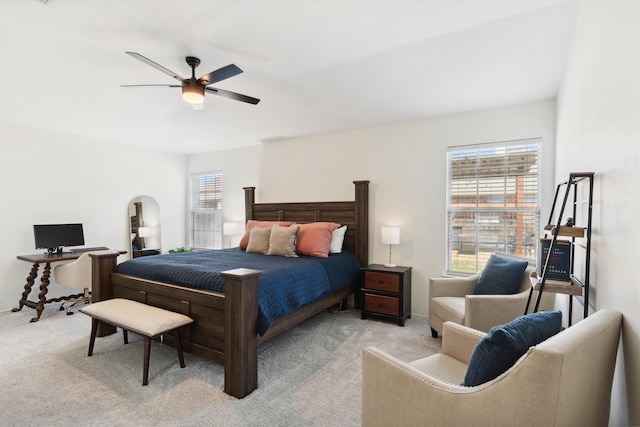 bedroom with light colored carpet and a ceiling fan