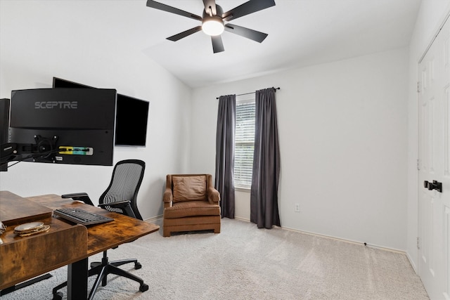 office area featuring ceiling fan, lofted ceiling, baseboards, and light carpet