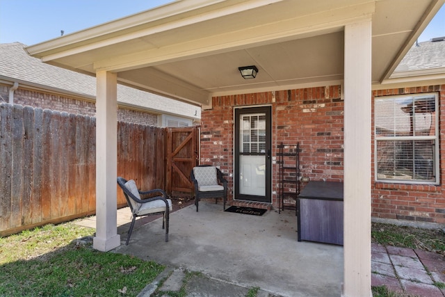 view of patio featuring a gate and fence