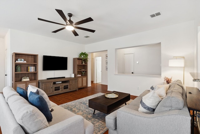 living room with a ceiling fan, wood finished floors, and visible vents