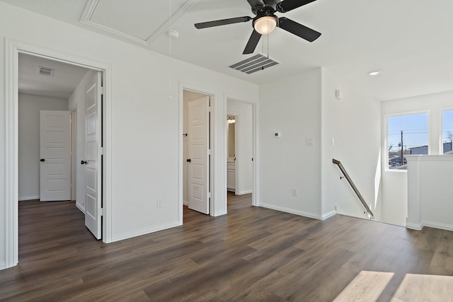 interior space featuring visible vents, baseboards, dark wood-type flooring, and attic access