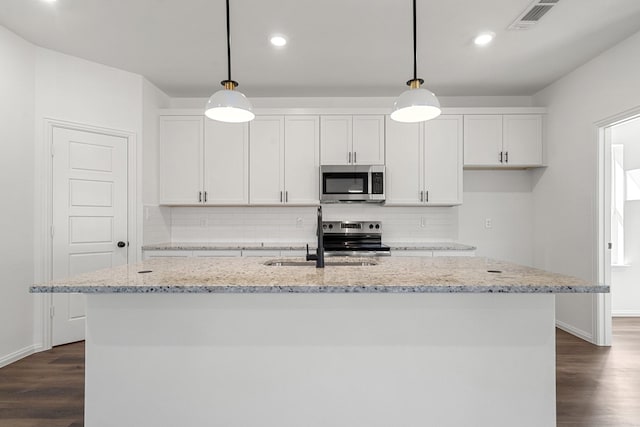 kitchen with a sink, visible vents, appliances with stainless steel finishes, and white cabinetry