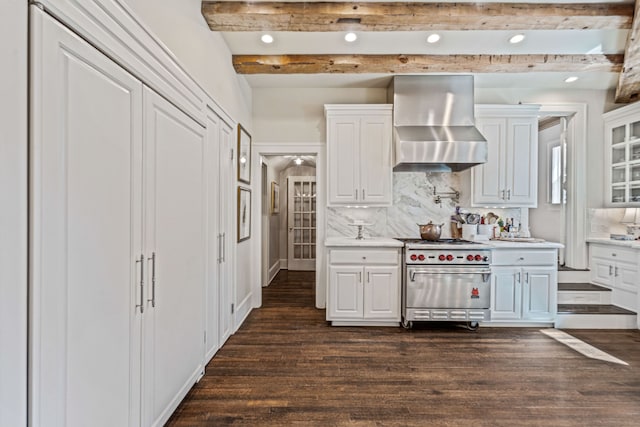 kitchen featuring wall chimney range hood, dark wood-style floors, beamed ceiling, and high end stove