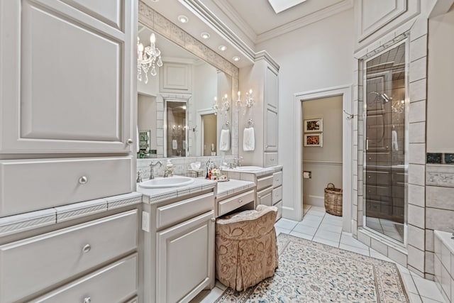 full bath with vanity, crown molding, a stall shower, and tile patterned flooring