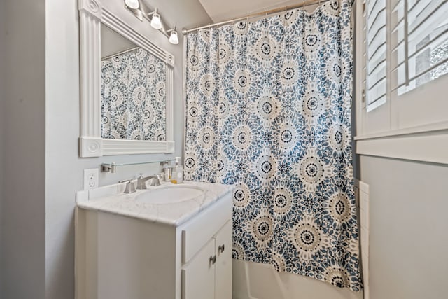 bathroom with shower / bath combination with curtain and vanity