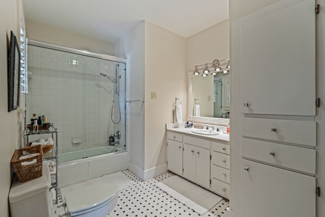 full bath with vanity, toilet, baseboards, and combined bath / shower with glass door