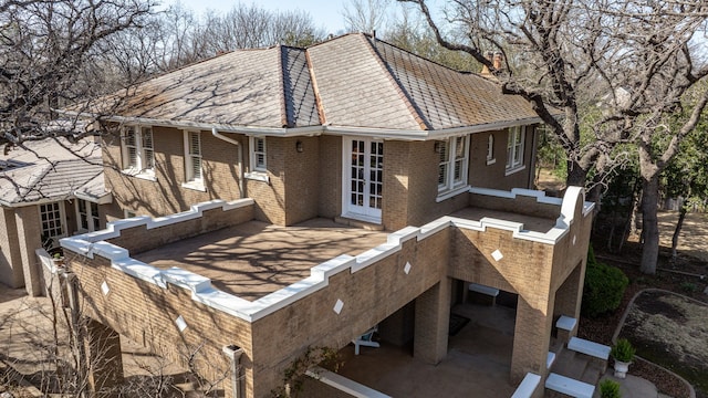 rear view of house featuring brick siding