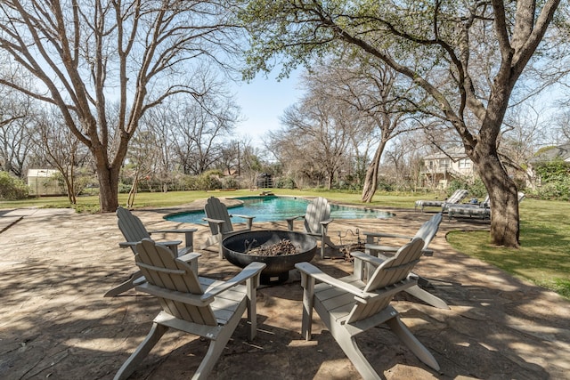 view of patio featuring a fire pit and an outdoor pool