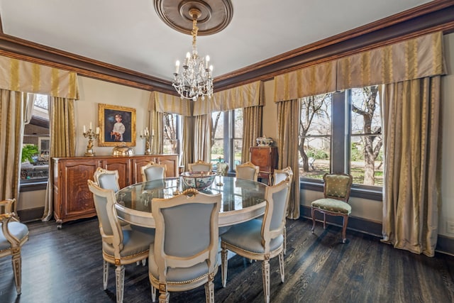 dining space featuring crown molding, a healthy amount of sunlight, and a chandelier