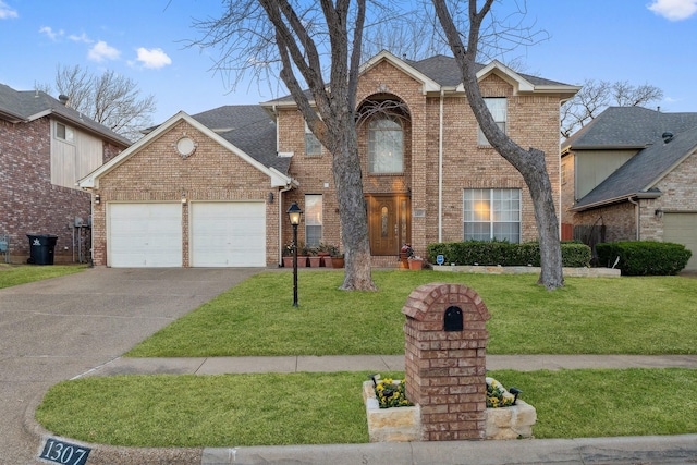 traditional-style house with brick siding, a front lawn, concrete driveway, roof with shingles, and a garage