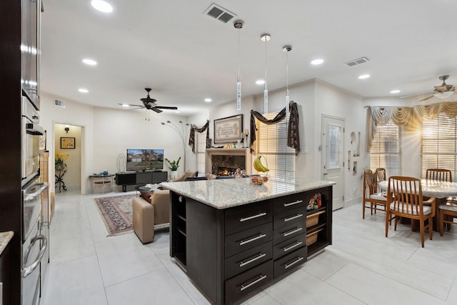 kitchen featuring recessed lighting, a fireplace, visible vents, and ceiling fan