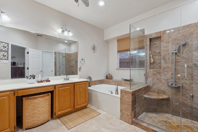 bathroom featuring tile patterned floors, a garden tub, a stall shower, and vanity