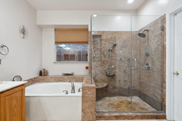 bathroom featuring vanity, a garden tub, and a shower stall