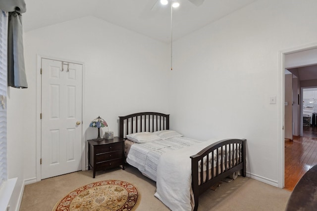 bedroom with vaulted ceiling, baseboards, and ceiling fan