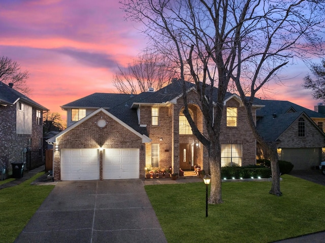 view of front of home featuring a front lawn, an attached garage, brick siding, and concrete driveway